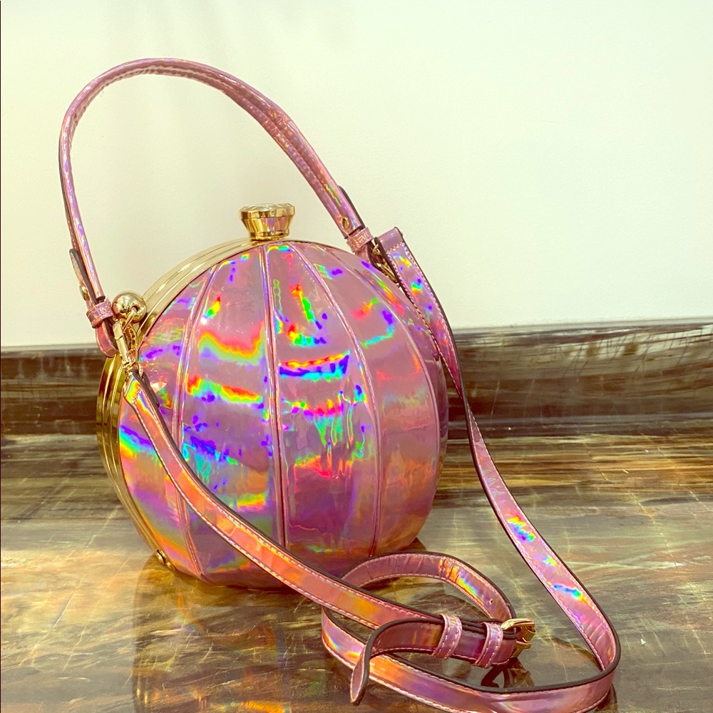 Round, snap-button, iridescent pink purse.
